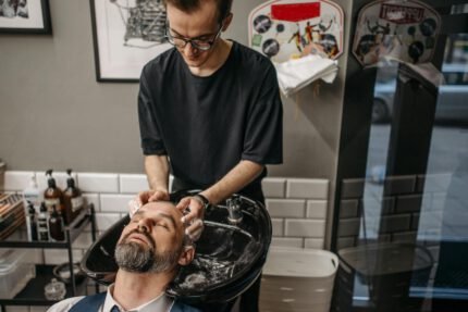 A Barber Shampooing a Client