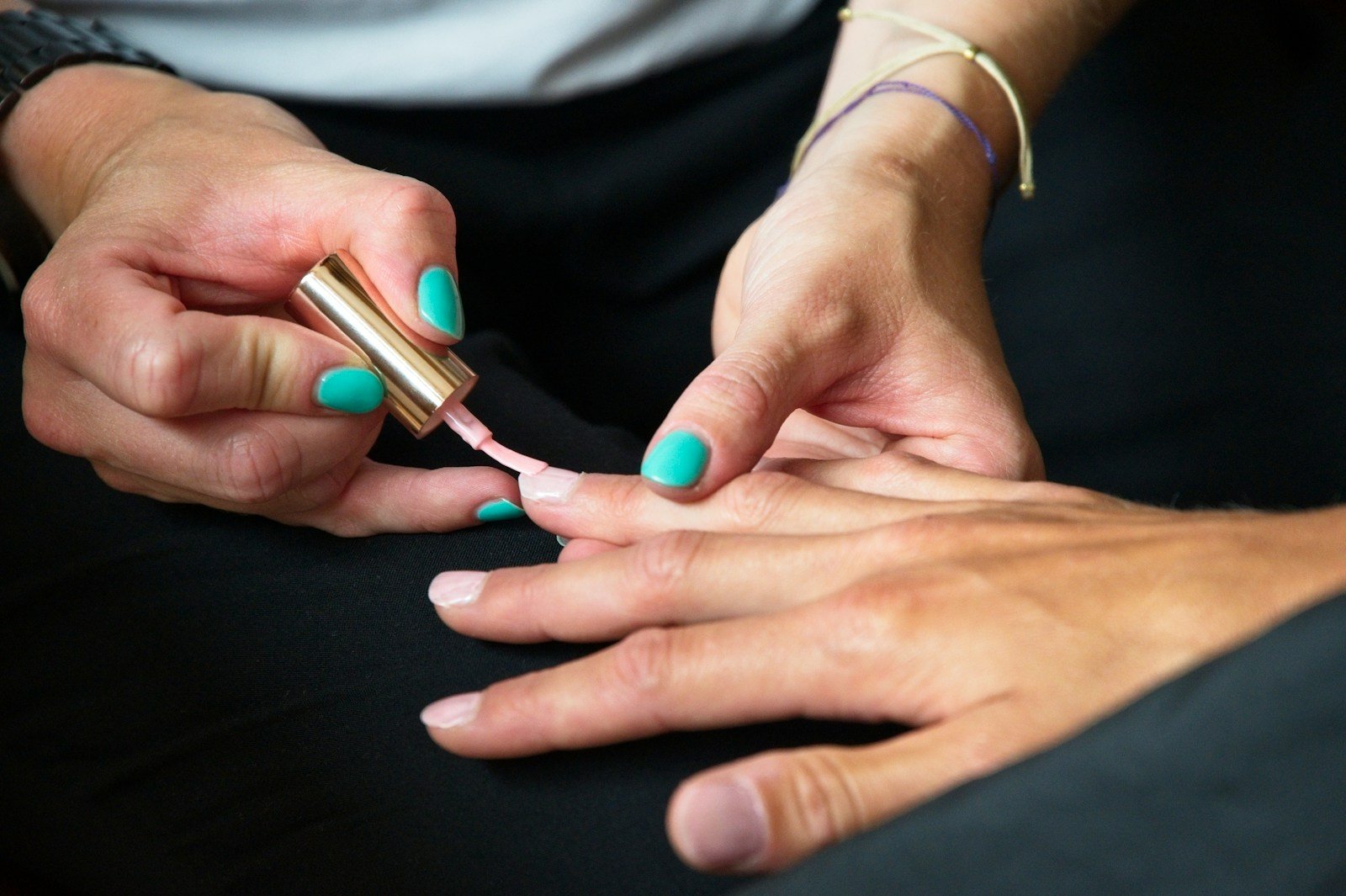 a person's hands with painted nails